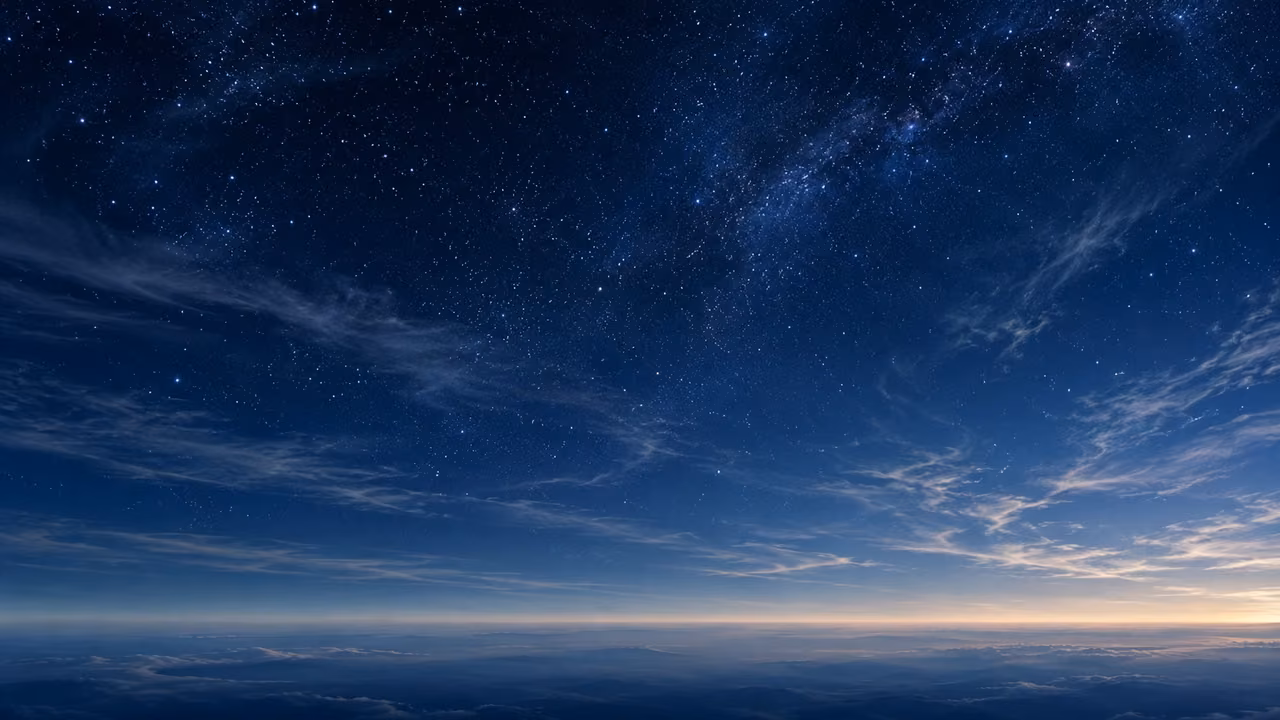 Fine stars and thin cloud fill a vast uninhabited sky.