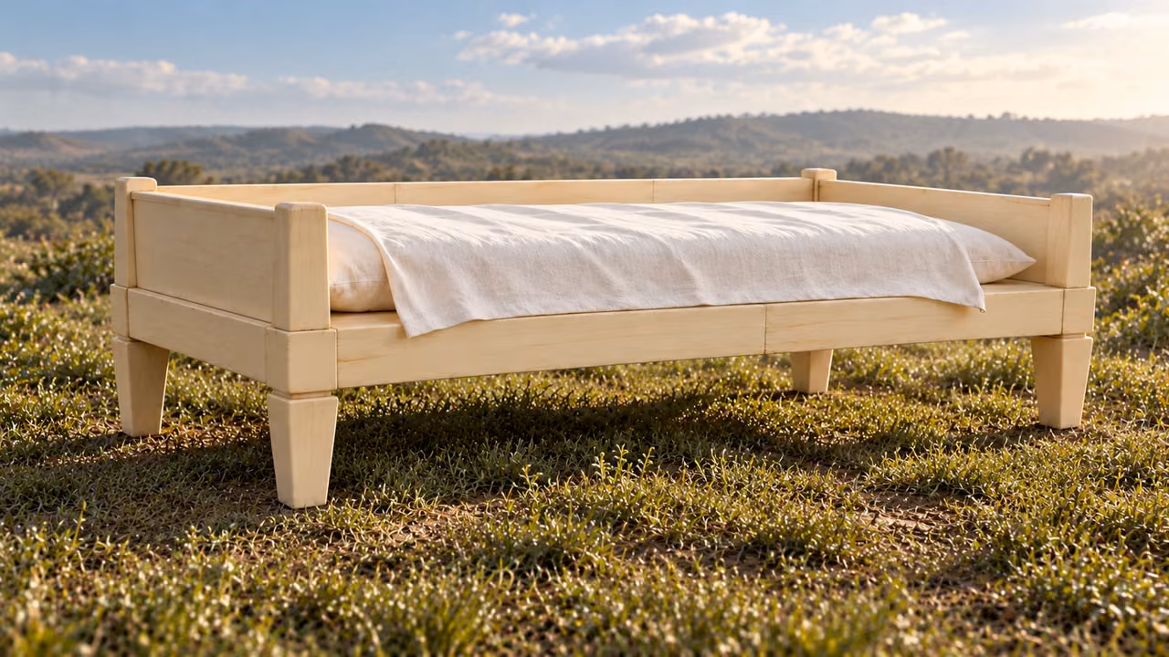 Illustrative vision detail: the empty ivory cushioned bench stands on exactly four feet on level grassy ground.